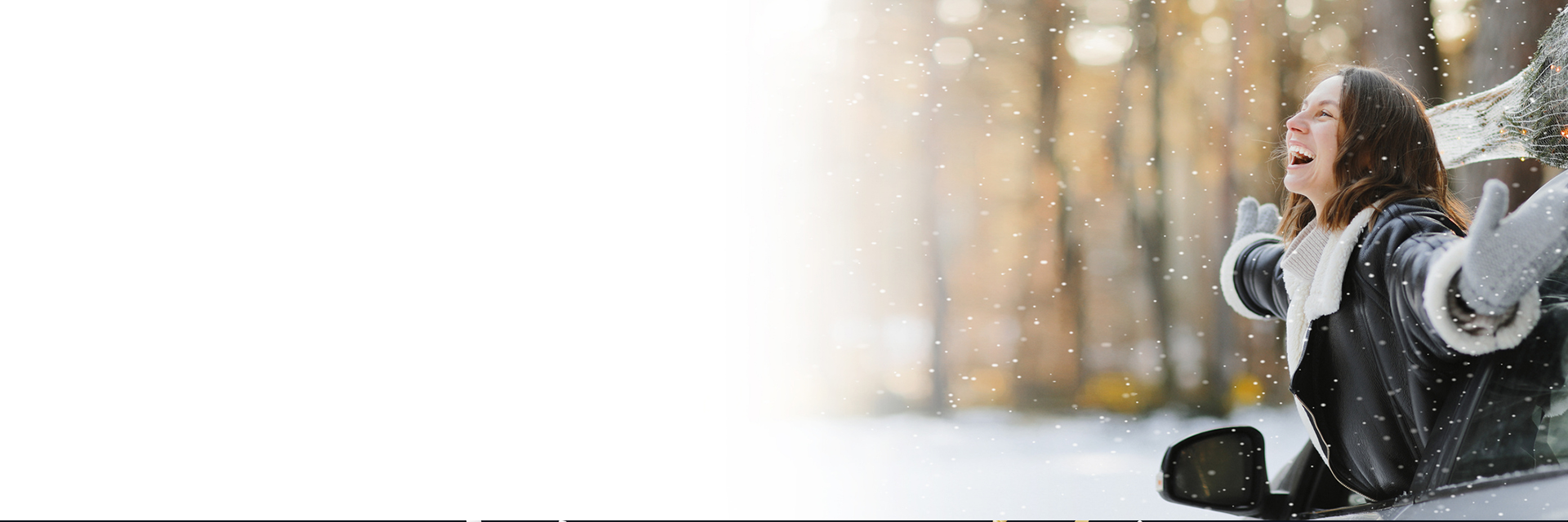 blue car driving through fall leaves